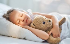 little girl sleeping teddy bear